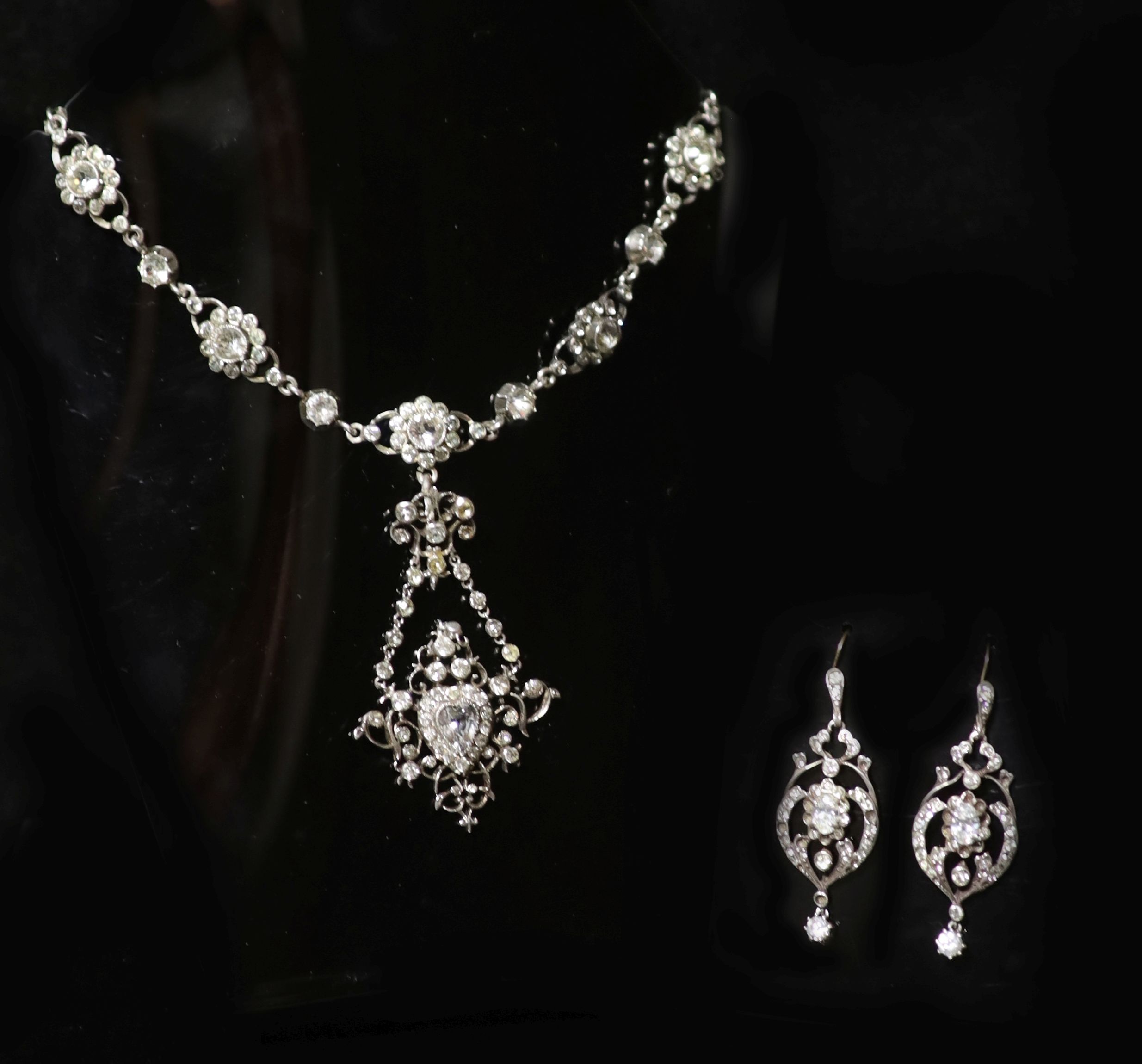 An ornate silver and paste set drop pendant necklace and pair of similar drop earrings